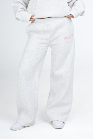 White fleece pants with pink text on a white background