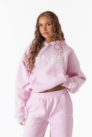 Woman wearing a pink hoodie with 'Kenzen' branding on a white background