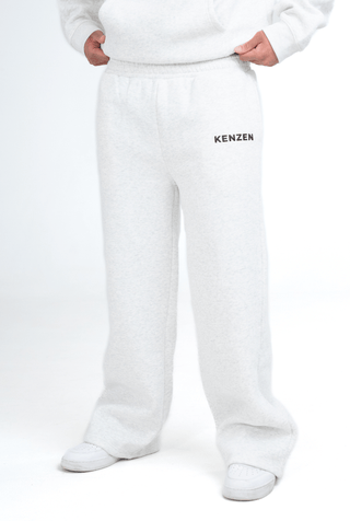 Person wearing a grey hoodie and pants with 'KENZEN' branding on a white background