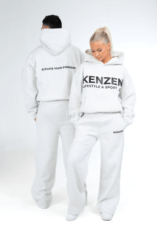 Person wearing a grey hoodie and pants with 'KENZEN' branding on a white background