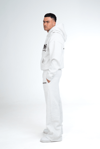 Person wearing a grey hoodie and pants with 'KENZEN' branding on a white background