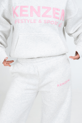 Person wearing a white hoodie and pants with 'KENZEN' branding on a white background