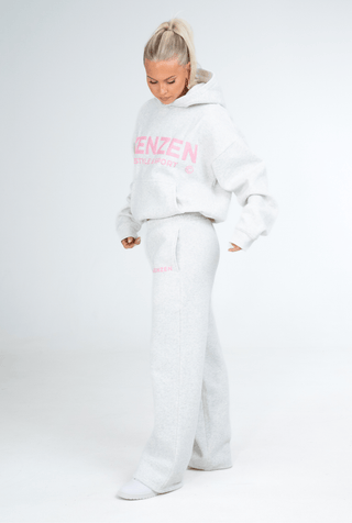 Person wearing a white hoodie and pants with 'KENZEN' branding on a white background