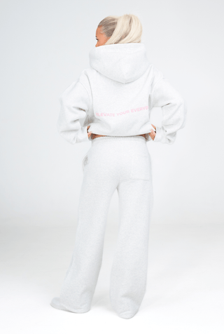 Person wearing a white hoodie and pants with 'KENZEN' branding on a white background