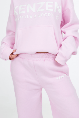 Pink tracksuit with 'Kenzen' branding on a light gray background