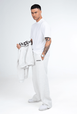 Person wearing a grey hoodie and pants with 'KENZEN' branding on a white background